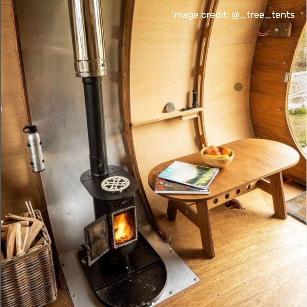 An Anevay small space wood burning stove set up in a Tree Tent cabin